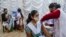 A health staff administers vaccine for COVID-19 to teens at a school in Kolkata, India, Jan. 3, 2022.