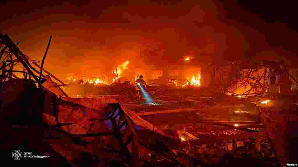 A rescuer works at the site of a Russian missile strike in Mykolaiv, Ukraine. (Press service of the State Emergency Service of Ukraine/Handout)