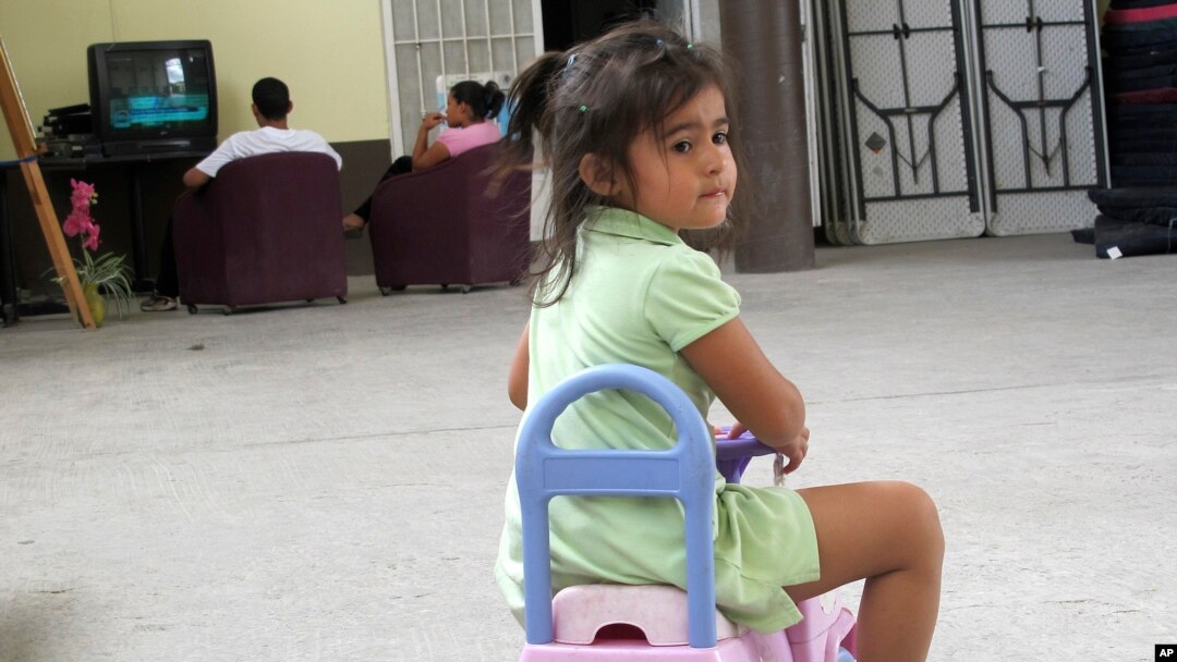 FILE - three-year-old Perla Calidono, of Copan, Honduras, plays at the Nuestra Senora de Guadalupe migrant shelter in Reynosa, Mexico. 