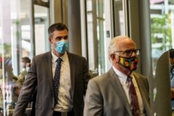 Former Minneapolis policeman Thomas Lane and his attorney exit the Hennepin County Public Safety Facility in Minneapolis, Minnesota, June 29, 2020.