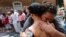 A couple embrace as they participate in prayers at the intersection where Heather Heyer was killed last year as they mark the anniversary of the Unite the Right rally in Charlottesville, Va., Aug. 12, 2018. On that day, white supremacists and counterprotesters clashed in the city streets before a car driven into a crowd struck and killed Heyer. 