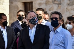 US Secretary of State Mike Pompeo, left, and Greek Prime Minister Kyriakos Mitsotakis visit the archeological site of Aptera, on the Greek island of Crete, Sept. 29, 2020.