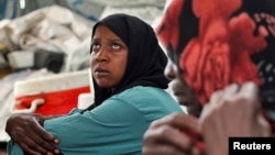 FILE - Families displaced by Rapid Support Forces advances in Sudan's El Gezira and Sennar states shelter at the Omar ibn al-Khattab displacement site, Kassala state, Sudan, July 10, 2024. Women-led groups plan to be a part of Sudan peace talks in Switzerland beginning Aug. 14.