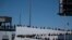 Asylum seekers walk for their asylum interview appointment with US authorities at the El Chaparral crossing port in Tijuana, Baja California State, Mexico, on May 18, 2024.