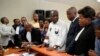 Accompanied by his wife and his lawyers, Congo opposition candidate Martin Fayulu, center, petitions the constitutional court following his loss in the presidential elections in Kinshasa, Congo, Saturday Jan. 12, 2019.