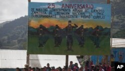 FILE - Members of the Zapatista National Liberation Army, EZLN, attend an event marking the 25th anniversary of the Zapatista uprising in La Realidad, Chiapas, Mexico, Jan. 1, 2019.