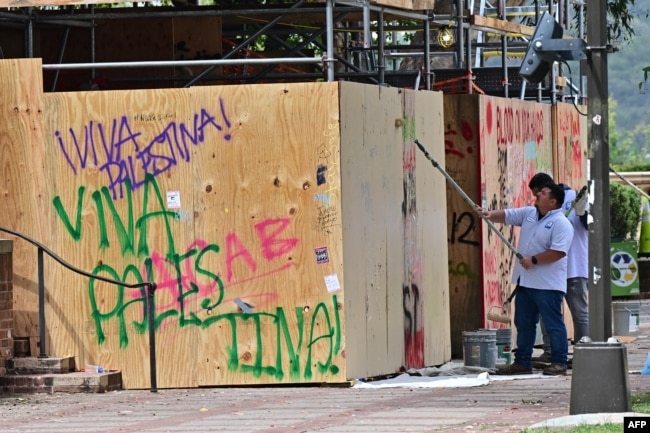 Workers clean up the University of California, Los Angeles (UCLA) campus after police evicted pro-Palestinian students, in Los Angeles, California, early on May 2, 2024.(Photo by Frederic J. Brown / AFP)