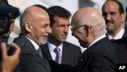 FILE - Sartaj Aziz, Pakistan's advisor on national security and foreign affairs, right, greets Afghan President Ashraf Ghani at Chaklala airbase in Rawalpindi, Pakistan, Nov. 14, 2014.