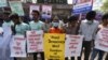 FILE - Activists hold placards during a demonstration demanding the repeal of the Digital Security Act, in Dhaka, Feb. 27, 2021.