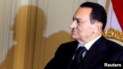 FILE - Then-President Hosni Mubarak attends a meeting with Qatar's Prime Minister Sheikh Hamad bin Jassim bin Jaber al-Thani at the presidential palace in Cairo, Dec. 11, 2010. 