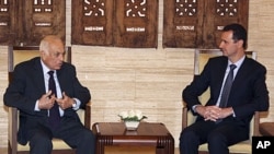 Syrian President Bashar al-Assad, right, meets with Arab League Secretary-General Nabil Elaraby at al-Shaab presidential palace in Damascus, Syria, Wednesday, July 13, 2011