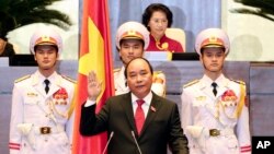 Nguyen Xuan Phuc, center, takes oath after being elected as prime minister in Hanoi, Vietnam Thursday April, 7, 2016.