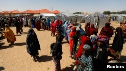 FILE: Women line up for relief at the Teachers' Village IDP camp in Maiduguri, Nigeria on Jan. 16, 2019. 