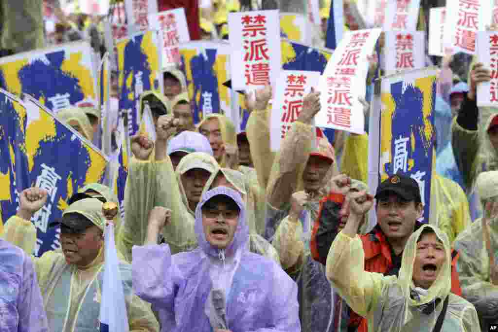 Labor rights activists shout while holding signs reading &quot;Forbid Temporary Worker Services&quot; during a rally for labor rights on international Labor Day in Taipei, Taiwan.