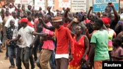 FILE - Supporters of Ugandan musician-turned-politician Robert Kyagulanyi Ssentamu, also known as Bobi Wine, chant slogans outside his home in Kampala, after he returned from the U.S., Sept. 20, 2018.