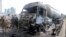 In this photo released by the Syrian official news agency SANA, Syrian security forces, emergency services and residents look at the remains of burned vehicles at the site of a bombing in Tartus, Syria, Sept. 5, 2016.