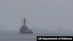 A Navy destroyer in the U.S. Central Command area of operations transits the Strait of Hormuz, April 11, 2026. 