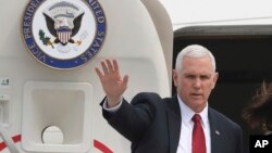 FILE - Vice President Mike Pence waves before leaving for Japan, at Osan Air Base in Pyeongtaek, South Korea, , April 18, 2017.