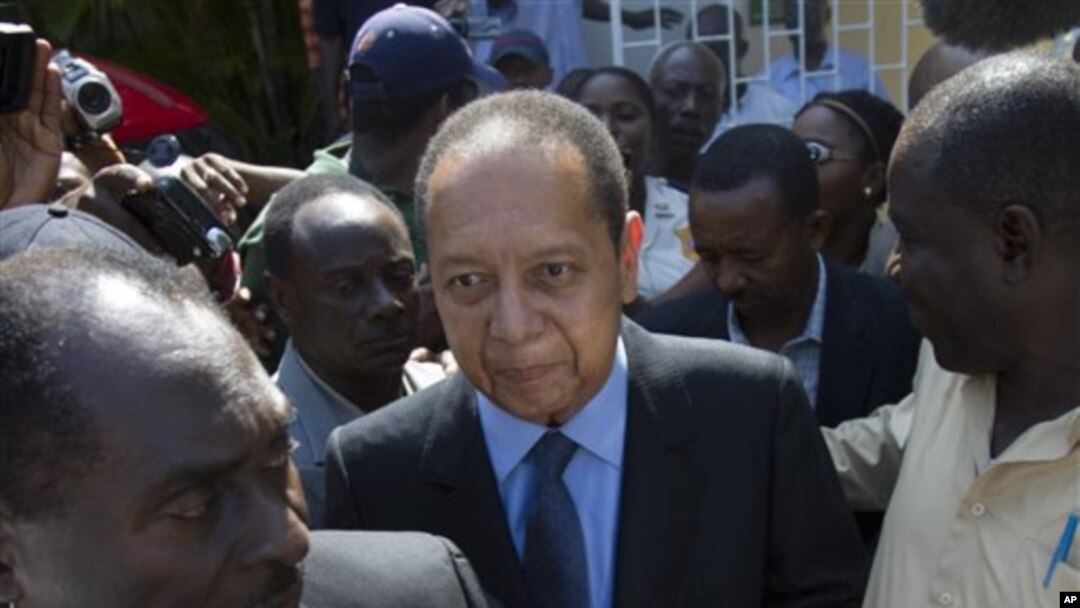 Former Haitian dictator Jean-Claude Duvalier, center, leaves Canape Vert Hospital in Port-au-Prince, Haiti, March 29, 2011