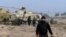 In this image taken from video obtained from the Ugarit News, which has been authenticated based on its contents and other AP reporting, Syrian rebels capture a helicopter air base near the capital Damascus after fierce fighting in Syria, on Sunday, Nov. 