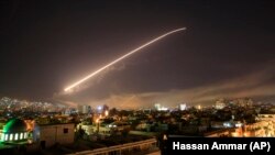 SYRIA – The Damascus sky lights up missile fire as the U.S. launches an attack on Syria targeting different parts of the capital early Saturday, April 14, 2018