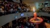 A man holds a candle at a prayer service on Christmas Eve at a church in Bandung, Indonesia, Dec. 24, 2017. Antara Foto/Novrian Arby/via Reuters