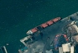 This satellite image from the Department of Justice shows what it says is the North Korean cargo ship Wise Honest docked at an unknown port. The Trump administration has seized the North Korean cargo ship used to supply coal in violation of international sanctions, May 9, 2018.