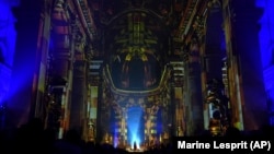 Video projections are seen at the Saint-Sulpice church in Paris, Oct. 31, 2024. (AP Photo/Marine Lesprit)