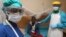 FILE - A nurse and doctor stand by a patient in a Lassa fever ward at Kenema Government Hospital in southeastern Sierra Leone, Feb. 7, 2011.