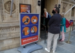 A welcome back sign requesting that people maintain precautions, is seen at the Royal Albert Hall in London, July 19, 2021.