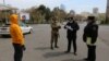 Azeri law enforcement officers and a serviceman check documents of a man after the authorities imposed restrictions on movement to prevent the spread of the coronavirus disease (COVID-19) in Baku, Azerbaijan, April 6, 2020. 
