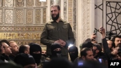 Islamist group Hayat Tahrir al-Sham (HTS) leader Abu Mohammed al-Jolani addresses a crowd at the capital's landmark Umayyad Mosque in Syria, on Dec. 8, 2024.