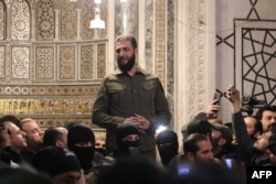 Islamist group Hayat Tahrir al-Sham (HTS) leader Abu Mohammed al-Jolani addresses a crowd at the capital's landmark Umayyad Mosque in Damascus, Syria, Dec. 8, 2024.