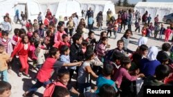 Syrian refugee children play at a makeshift school, supported by UNICEF and in cooperation with the Beyond Association, in Zahle in the Bekaa valley.