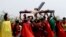Devotees dressed as Roman soldiers lift Ruben Enaje on the cross after he was nailed to it for his 32nd time during a re-enactment of Jesus Christ's sufferings as part of Good Friday rituals in the village of San Pedro Cutud, Pampanga province, northern Philippines, March 30, 2018. 