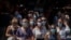 Tourists wearing face masks wait to cross a road in downtown Barcelona, Spain, July 16, 2020.