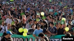 People participate in the so-called "Last demonstration with illegal marijuana" on their way to the Congress building in Montevideo, as Senate debates a government-sponsored bill establishing state regulation of the cultivation, distribution and consumption of marijuana during a session, December 10, 2013. 