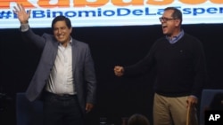 Esperanza-UNES- alliance party presidential candidate Andres Arauz, left, and his running mate Carlos Rabascall celebrate as they wait for the official results Feb. 7, 2021.