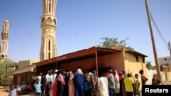 People gather to get bread in Khartoum North