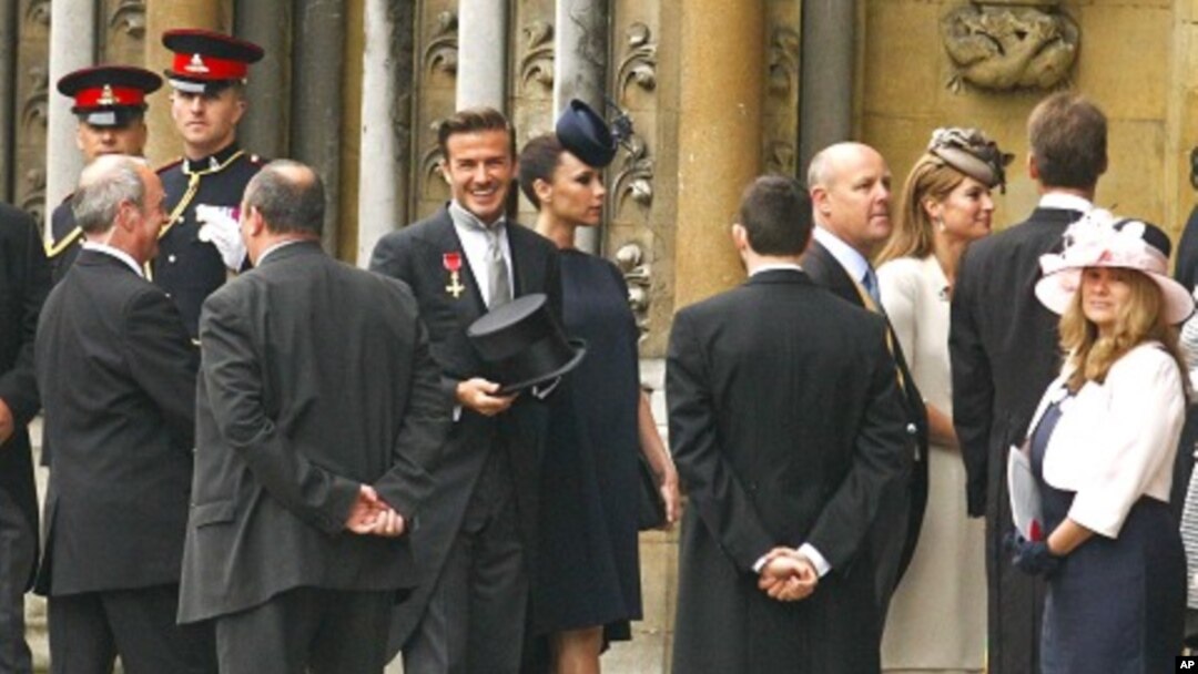 Soccer star David Beckham (C) and his wife Victoria arrive at Westminster Abbey before the wedding of Britain's Prince William and Kate Middleton, in central London April 29, 2011.