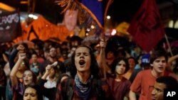 People protest government education budget cuts in Rio de Janeiro, Brazil, Aug. 13, 2019.