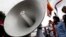 Cambodian protesters use a loudspeaker for express their comment during a protest at a blocked main street in front of Vietnamese Embassy in Phnom Penh, Cambodia, Wednesday, Oct. 8, 2014. The protesters on Wednesday demanded the Vietnamese government to a