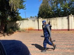 Armed police guarding journalistic equipment of Hopewell Chin'ono in Harare, July 21, 2020. (VOA/Columbus Mavhunga)