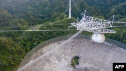 This aerial view shows a hole in the dish panels of the Arecibo Observatory in Arecibo, Puerto Rico, Nov. 19, 2020. 