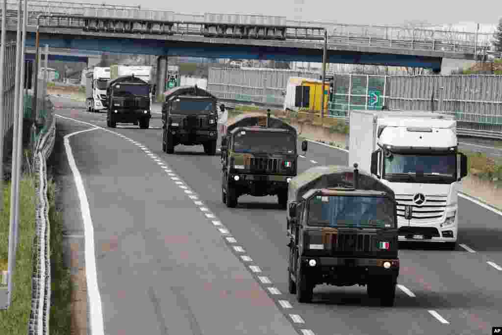 Military trucks carry coffins of those who have died from COVID-19, from one cemetery in Bergamo, Italy, to another, after the local crematorium exceeded its maximum capacity.