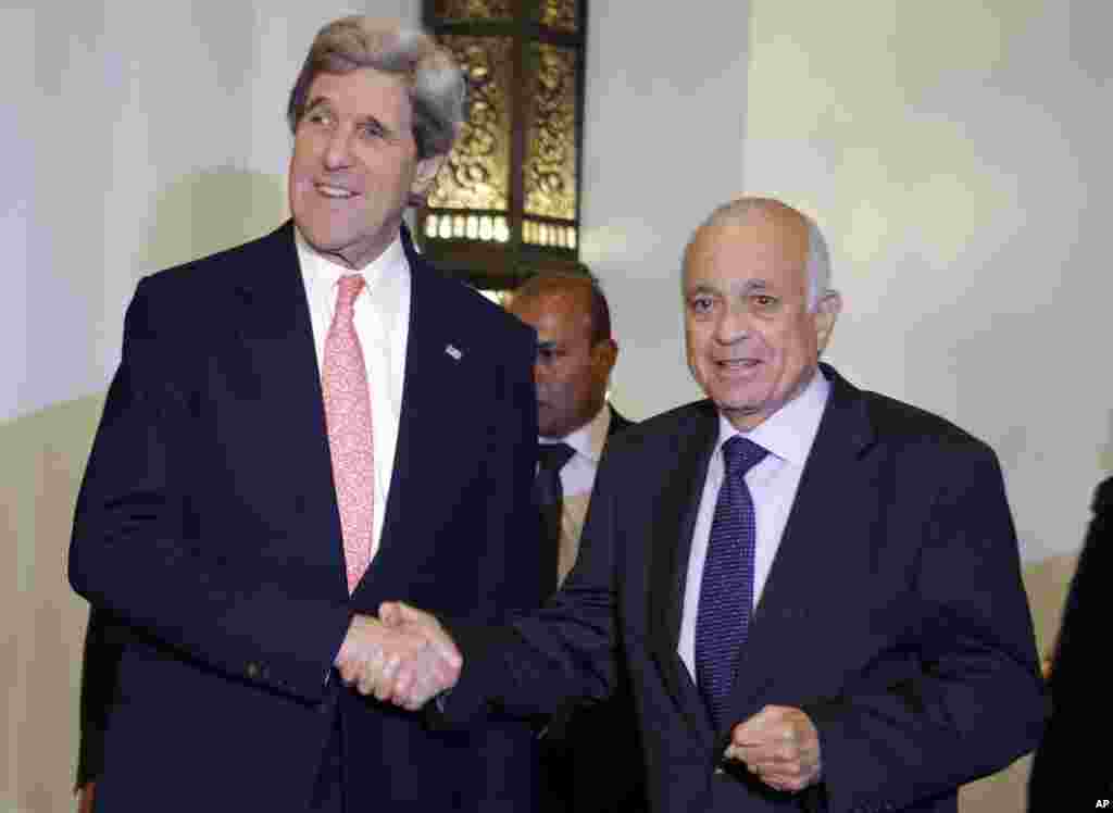 U.S. Secretary of State John Kerry, left, poses for a photograph with Arab League Secretary General Nabil Elaraby, after their meeting in Cairo, March 2, 2013.