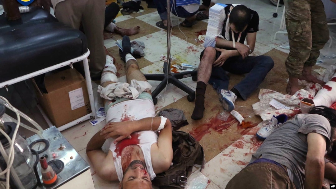 Wounded men receive treatment at a local clinic after airstrikes hit in Aleppo, Syria, Sept. 24, 2016. 