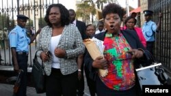 Kenyan members of parliament Gladys Wanga, left, and Christine Mbaya leave the National Assembly to protest the approval of new anti-terrorism laws in Kenya's capital Nairobi, Dec. 18, 2014.