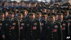 Military delegates march to the Great Hall of the People to attend a plenary session of China's National People's Congress, in Beijing, March 8, 2025.