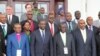 Uganda VP Edward Sekandi, second left, front row, Uganda PM Ruhakana Rugunda, right, and East African Community Secretary-General Dr. Sezibwera, second right, pose with others, during Burundi peace talks, at Entebbe State House, Dec. 28, 2015.